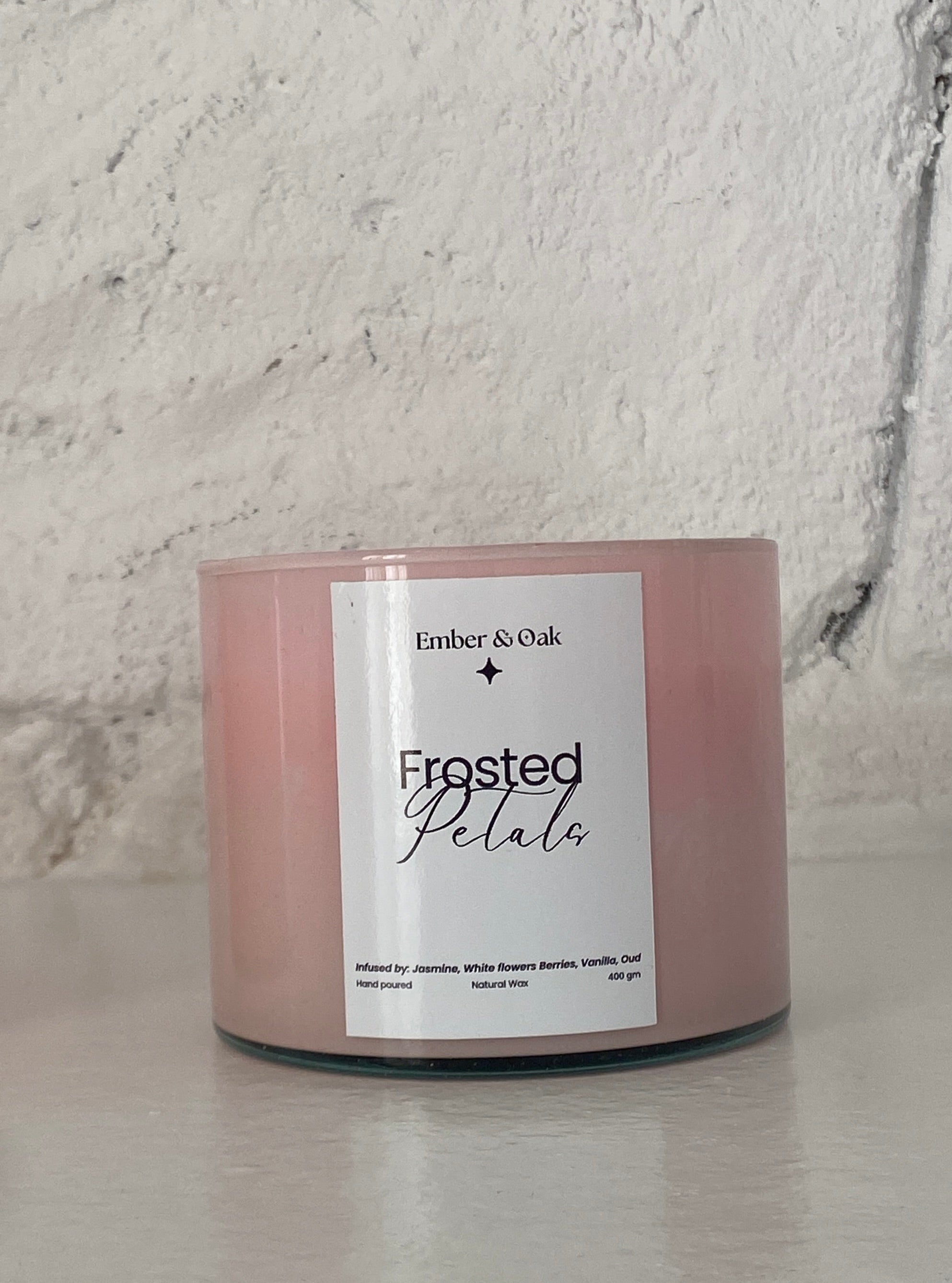 Candle with a label on a white surface and light gray background